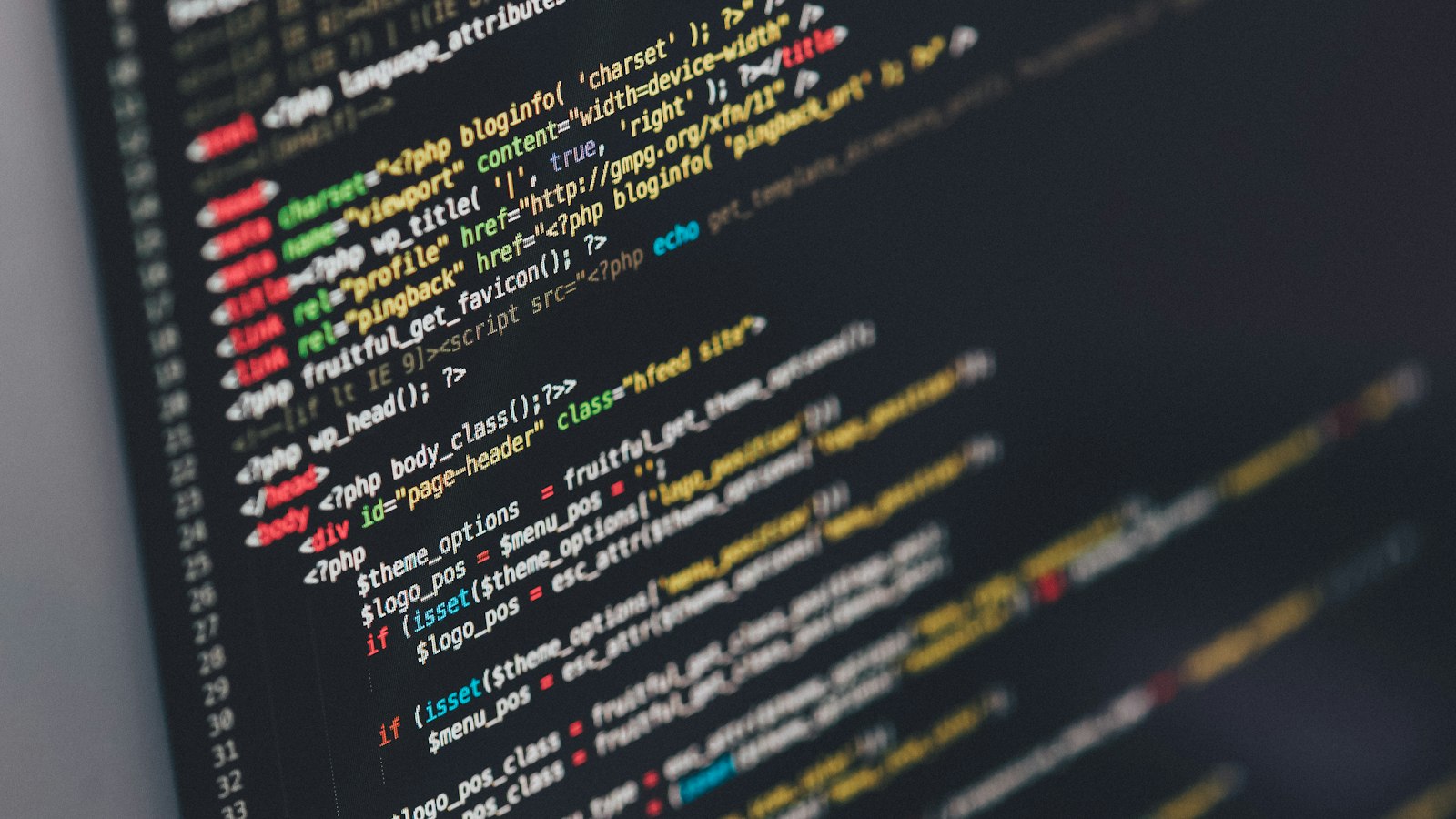Developer reviewing code on screen deciding whether to optimize or rebuild the application